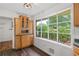 Bright breakfast nook with ample storage, hardwood floor, and large window with views of the backyard garden at 2644 Hickory Valley Dr, Snellville, GA 30078