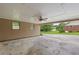 Open carport with ceiling fan and backyard view at 2644 Hickory Valley Dr, Snellville, GA 30078