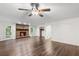 Open-concept living area featuring hardwood floors, a brick fireplace and lots of sunlight at 2644 Hickory Valley Dr, Snellville, GA 30078