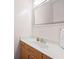 Well-lit bathroom showcasing a large mirror, modern sink, and stylish wood cabinets at 1308 Fernwood Ne Cir, Atlanta, GA 30319