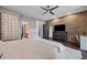 Modern bedroom features a brick wall, ceiling fan, glass block partition, and dark wood floors at 1308 Fernwood Ne Cir, Atlanta, GA 30319