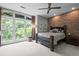 Bedroom features a brick wall accent, large windows with a natural view, and carpeted floors at 1308 Fernwood Ne Cir, Atlanta, GA 30319
