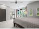 Bedroom featuring natural light from a large window, a ceiling fan, and a dedicated desk area at 1308 Fernwood Ne Cir, Atlanta, GA 30319