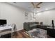 Bonus room featuring a sectional couch, desk area, hardwood flooring, and ceiling fan at 1308 Fernwood Ne Cir, Atlanta, GA 30319