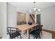 Bright dining room boasts a modern light fixture, minimalist decor, exposed brick and access to the staircase at 1308 Fernwood Ne Cir, Atlanta, GA 30319