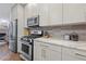 This kitchen features stainless steel appliances, marble countertops, and modern cabinetry for a sleek and functional cooking space at 1308 Fernwood Ne Cir, Atlanta, GA 30319
