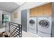 Upstairs laundry room with washer, dryer, and storage cabinets at 1308 Fernwood Ne Cir, Atlanta, GA 30319