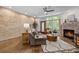 Cozy living room featuring hardwood floors, exposed brick wall, a fireplace and large windows for natural light at 1308 Fernwood Ne Cir, Atlanta, GA 30319