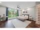 The primary bedroom features a large window, a stylish accent wall, and a comfortable rug for a peaceful retreat at 1308 Fernwood Ne Cir, Atlanta, GA 30319