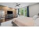 The main bedroom features a brick accent wall, a large window with natural light, and modern furniture for a relaxing atmosphere at 1308 Fernwood Ne Cir, Atlanta, GA 30319