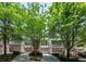 Stunning townhomes boasting manicured lawns, driveways and staircases leading to covered balconies, complemented by mature landscaping at 1308 Fernwood Ne Cir, Atlanta, GA 30319