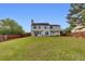 Spacious backyard featuring a well-maintained lawn, patio, and wooden fence for outdoor enjoyment at 1942 Westover Nw Ln, Kennesaw, GA 30152