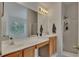 Bright bathroom with double vanity, large mirror, walk-in shower and a window with natural light at 1942 Westover Nw Ln, Kennesaw, GA 30152