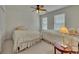 Cozy bedroom with two twin beds, neutral decor, carpet flooring, and natural light from two windows at 1942 Westover Nw Ln, Kennesaw, GA 30152