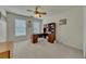 Bedroom features an office setup with carpet, a ceiling fan, and lots of natural light at 1942 Westover Nw Ln, Kennesaw, GA 30152