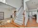 Bright foyer with hardwood floors, staircase, and an open view into the dining room at 1942 Westover Nw Ln, Kennesaw, GA 30152