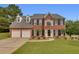 Beautiful brick two-story home with a well-manicured lawn, attached two car garage, and tasteful landscaping at 1942 Westover Nw Ln, Kennesaw, GA 30152