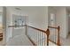 Open upstairs hallway with carpet flooring, white railing and natural light from the arched window at 1942 Westover Nw Ln, Kennesaw, GA 30152