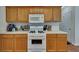 Galley kitchen with wooden cabinets, white appliances, a gas range, and white countertops at 1942 Westover Nw Ln, Kennesaw, GA 30152