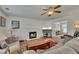 Cozy living room featuring a fireplace, ceiling fan, and plush sofa at 1942 Westover Nw Ln, Kennesaw, GA 30152