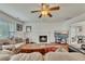 Comfortable living room with a fireplace, ceiling fan, and plush furnishings at 1942 Westover Nw Ln, Kennesaw, GA 30152