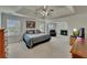 Spacious main bedroom with ceiling fan, fireplace, sitting area, and natural light at 1942 Westover Nw Ln, Kennesaw, GA 30152