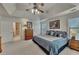 Generous main bedroom with tray ceiling, ceiling fan, two windows, and ensuite bathroom at 1942 Westover Nw Ln, Kennesaw, GA 30152