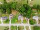 Aerial view of suburban home with well-maintained landscaping, mature trees and a long driveway at 2881 Bridle Creek Sw Dr, Conyers, GA 30094