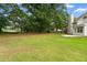 Large backyard with mature trees, providing ample space for outdoor activities and entertainment at 2881 Bridle Creek Sw Dr, Conyers, GA 30094