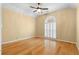 An inviting bedroom featuring hardwood floors, ample natural light, and a ceiling fan at 2881 Bridle Creek Sw Dr, Conyers, GA 30094