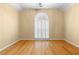 A spacious bedroom with hardwood floors, a large window with shutters, and natural light at 2881 Bridle Creek Sw Dr, Conyers, GA 30094