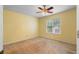 An empty bedroom with carpet flooring and a window with a view of the outside at 2881 Bridle Creek Sw Dr, Conyers, GA 30094