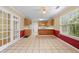 A tiled dining area adjacent to the kitchen, featuring a bright window and glass paneled doors at 2881 Bridle Creek Sw Dr, Conyers, GA 30094