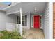 A welcoming front porch with a vibrant red door, white railing, and a pop of colorful flowers at 2881 Bridle Creek Sw Dr, Conyers, GA 30094