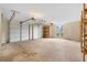 Spacious two-car garage with two garage doors, an arched window, and built-in shelving on a concrete floor at 2881 Bridle Creek Sw Dr, Conyers, GA 30094