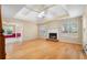 Bright living room boasting hardwood floors, a tray ceiling with fan, and a fireplace for cozy evenings at 2881 Bridle Creek Sw Dr, Conyers, GA 30094