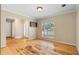 Bright and airy living room featuring hardwood floors and natural light, with views of the outdoor landscape at 2881 Bridle Creek Sw Dr, Conyers, GA 30094