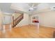 Open-concept living space showcasing hardwood floors, stairs to the upper level, and seamless flow to the kitchen at 2881 Bridle Creek Sw Dr, Conyers, GA 30094