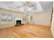 Spacious living room featuring a cozy fireplace, hardwood floors, and abundant natural light from large windows at 2881 Bridle Creek Sw Dr, Conyers, GA 30094