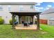 Backyard featuring a patio area with grill, shed, and seating area with a lush green lawn at 405 Highbranch Cir, Lawrenceville, GA 30044