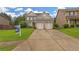 Charming two-story home featuring a brick facade, two-car garage, and well-maintained lawn at 405 Highbranch Cir, Lawrenceville, GA 30044