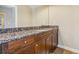 Bathroom features a granite countertop, wood cabinets, and a well-lit vanity mirror at 4541 Gateway Se Ct, Smyrna, GA 30080
