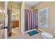 Bathroom featuring granite countertops, wood cabinets, and a combination shower and bathtub at 4541 Gateway Se Ct, Smyrna, GA 30080