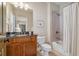 Bathroom with a vanity and granite countertop paired with a shower and tub with a white curtain at 4541 Gateway Se Ct, Smyrna, GA 30080