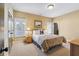 Cozy bedroom featuring tan walls, carpet, and natural light from two windows with wooden nightstands at 4541 Gateway Se Ct, Smyrna, GA 30080