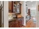 Elegant butler's pantry with granite counters, dark wood cabinetry, and hardwood floors at 4541 Gateway Se Ct, Smyrna, GA 30080