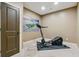 This exercise room has an elliptical machine, neutral carpet, base molding, and a sporty Penn State Nittany Lions theme at 4541 Gateway Se Ct, Smyrna, GA 30080