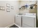 Laundry room featuring white washer and dryer, overhead storage shelves, and neutral wall color at 4541 Gateway Se Ct, Smyrna, GA 30080
