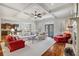 Open living room with coffered ceilings, hardwood floors, and access to the kitchen and outdoor patio at 4541 Gateway Se Ct, Smyrna, GA 30080