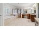 Bright bathroom with tile flooring, soaking tub, walk-in shower, and dual vanities at 4541 Gateway Se Ct, Smyrna, GA 30080